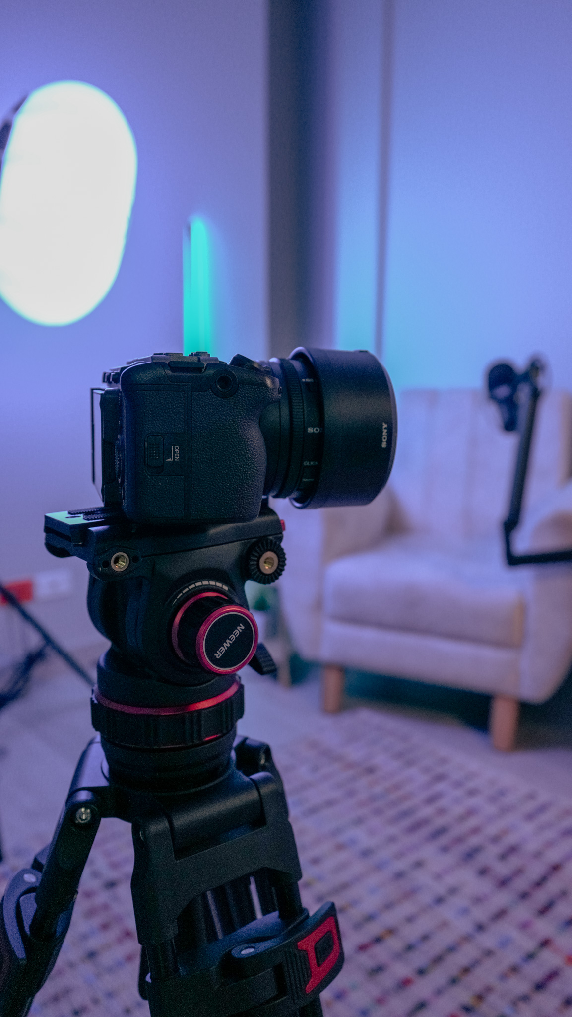 Close-up of camera lens and fluid tripod head