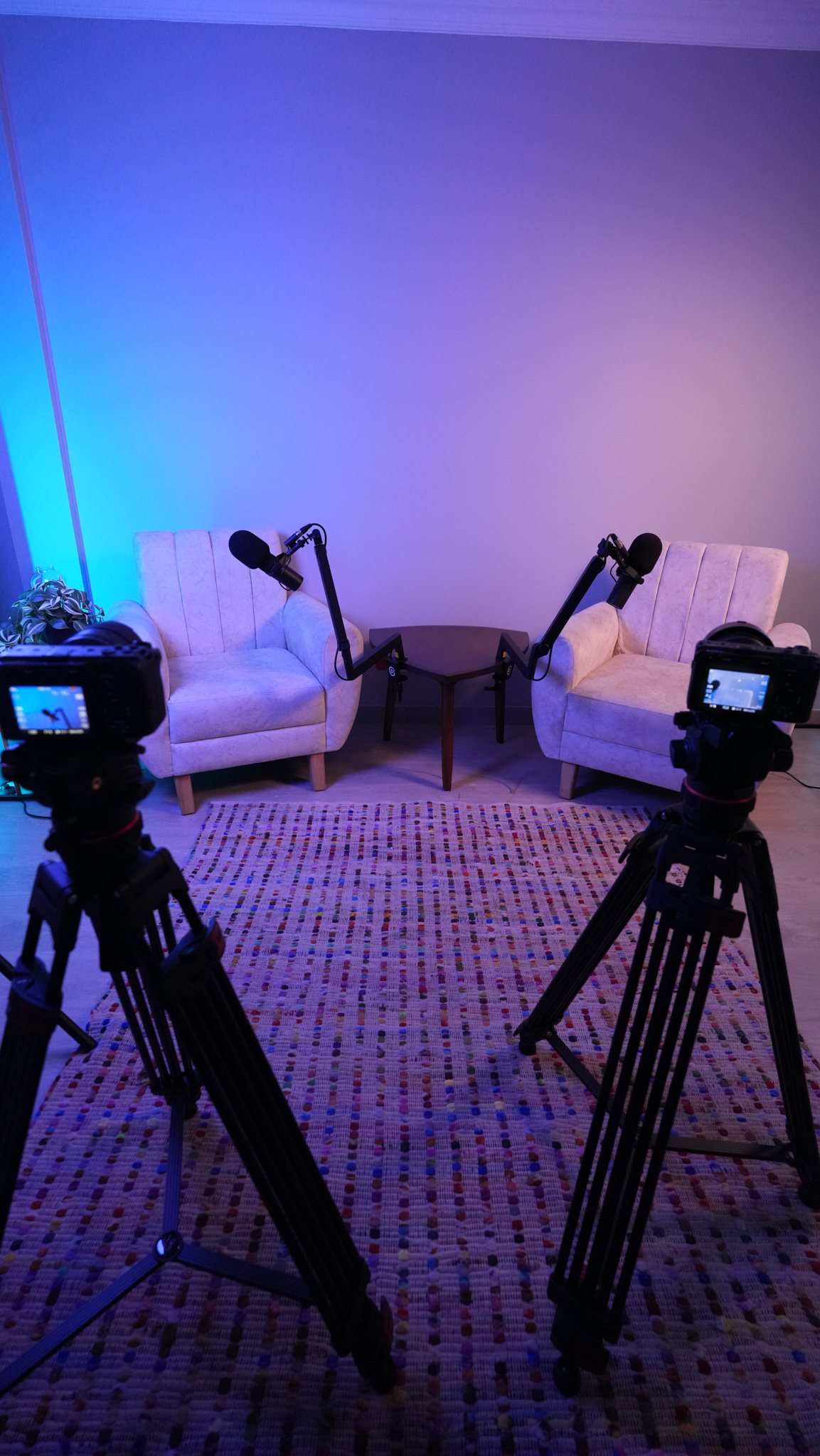 Two cameras aimed at podcast chairs for multi-angle recording
