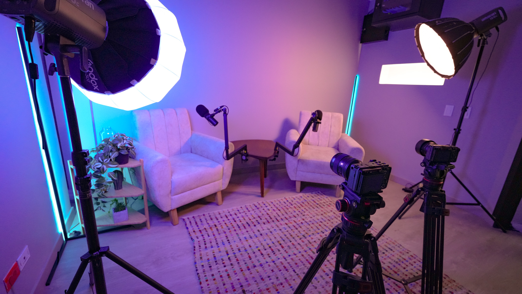 Podcast set with armchairs, mics, and professional lighting