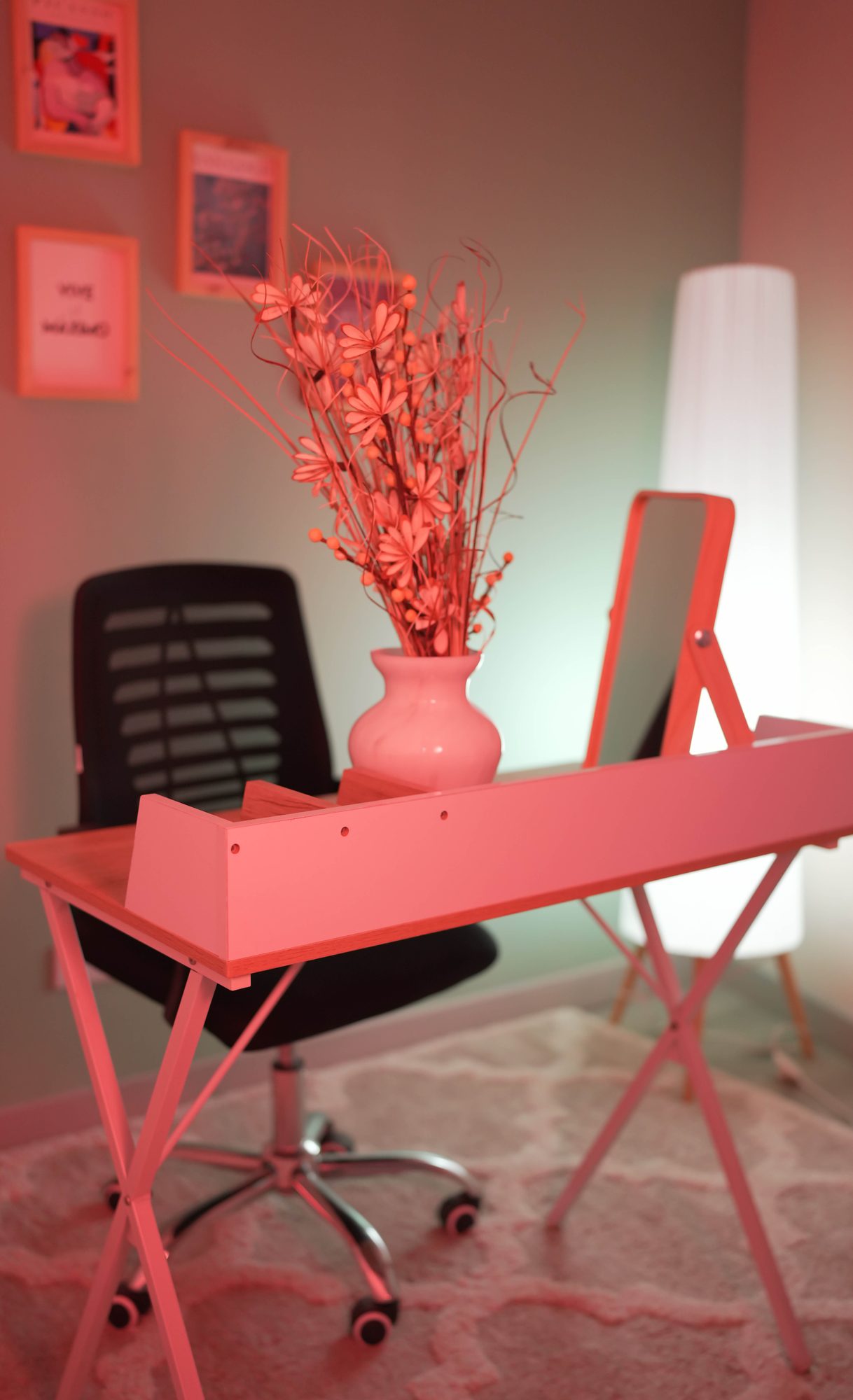 Pink streaming desk with laptop and gallery wall