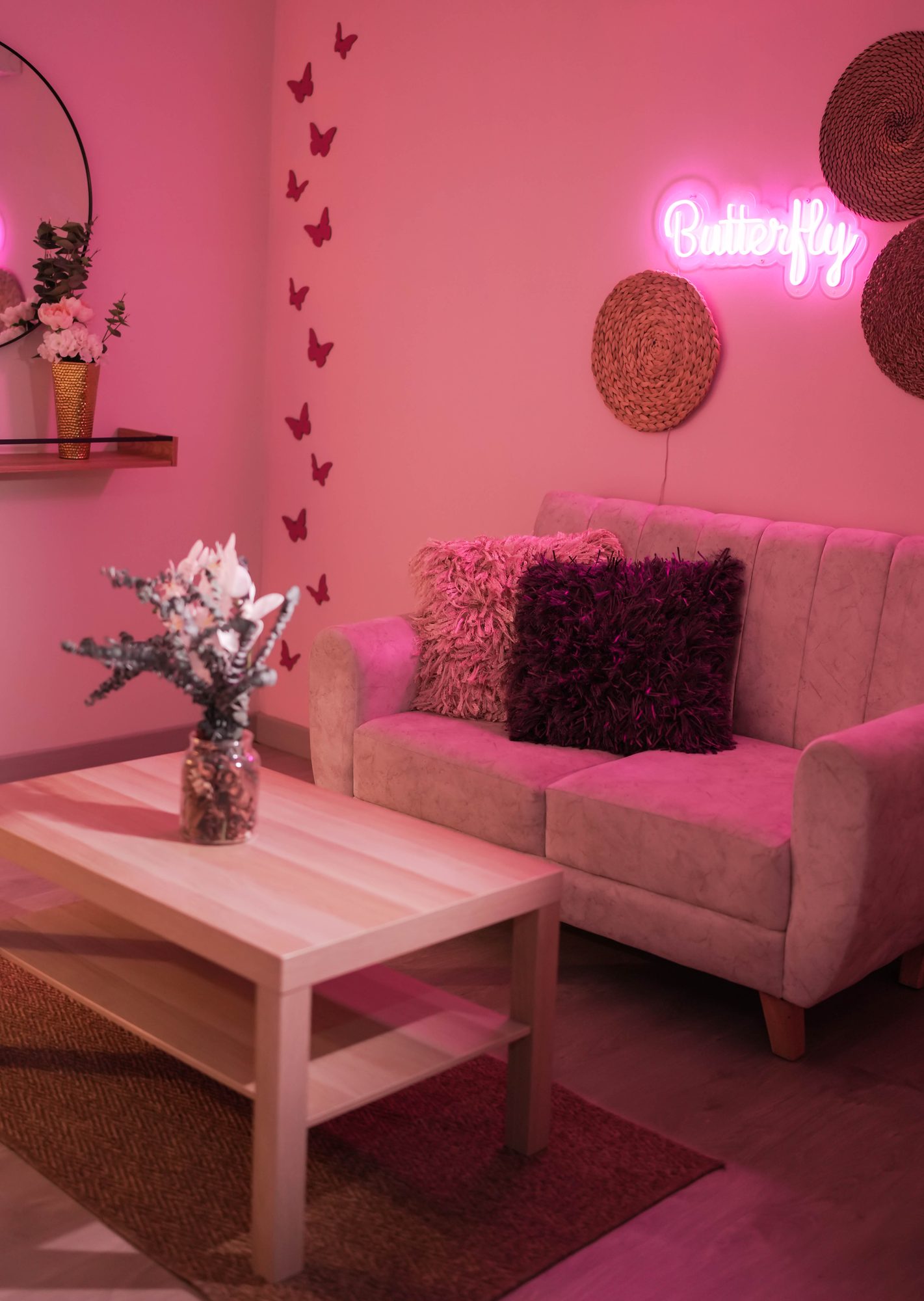 Pink lounge content room with white couch and neon sign