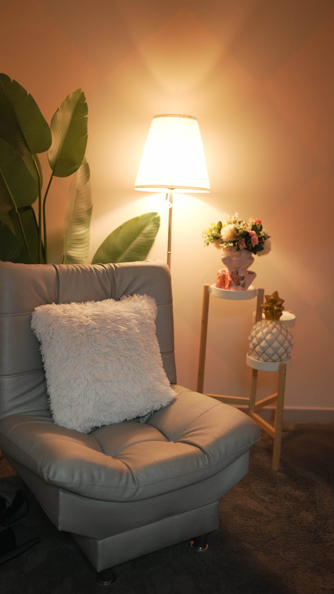 Cozy reading and interview nook with gray chair and lamp