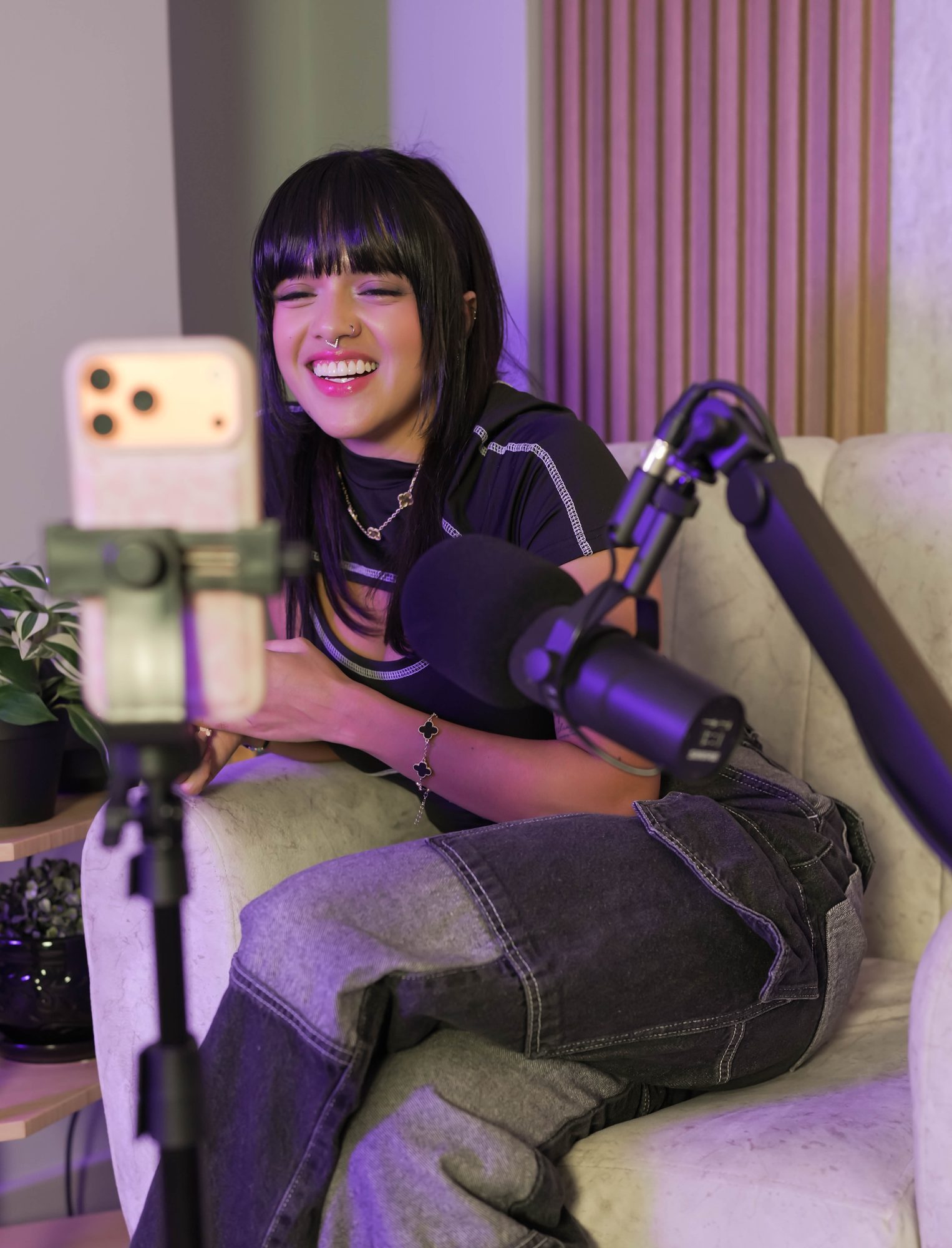 Podcast couch recording setup with boom mic and phone tripod